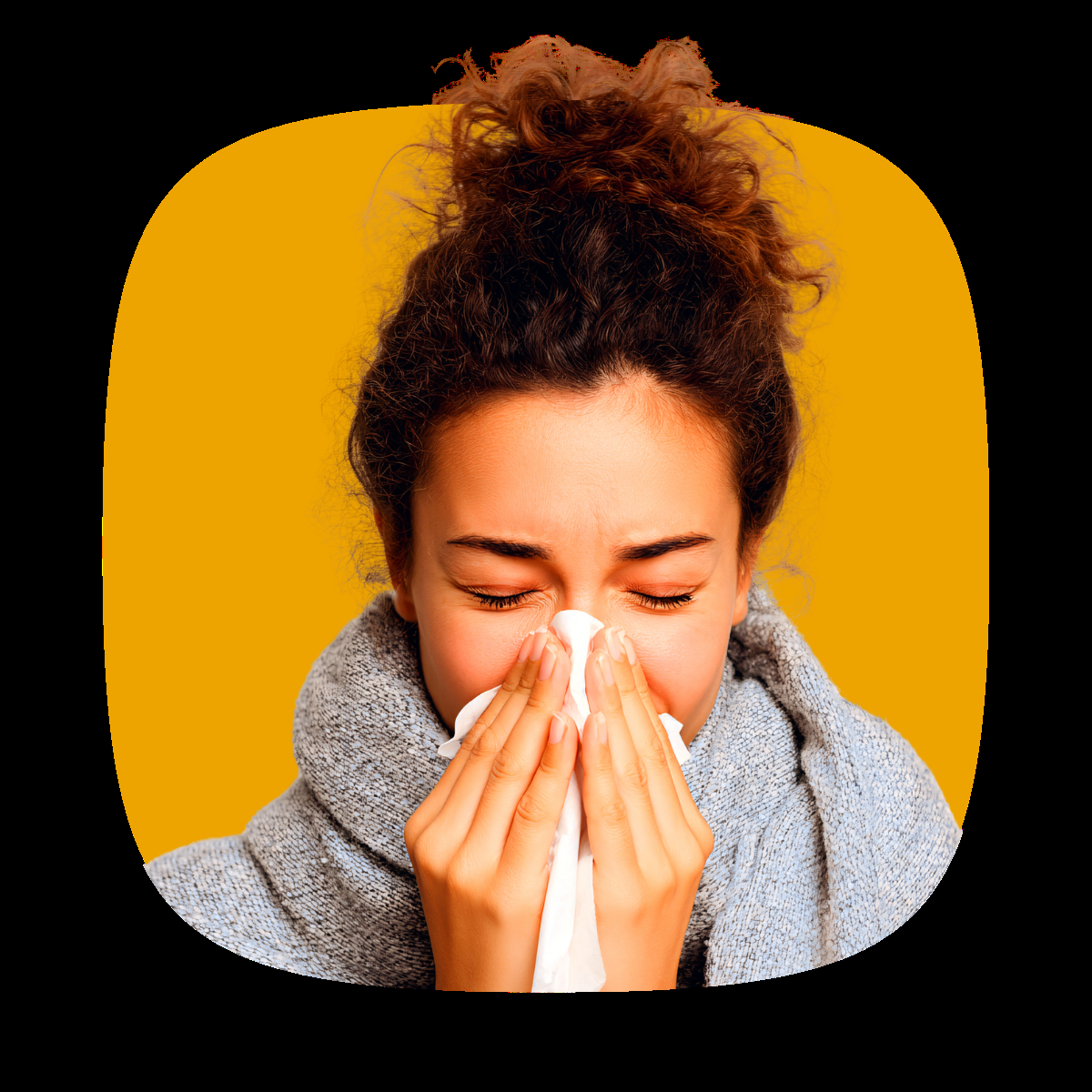 A woman sneezes into a tissue during flu season