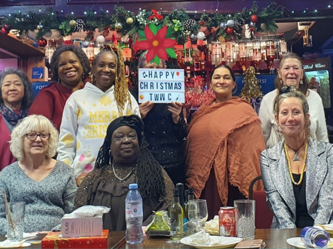 The Wild Women Collective posing for a group photo at a Christmas get together in the Cabin