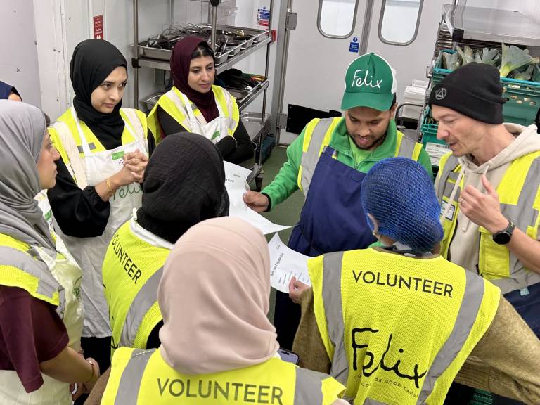 Volunteer cooks go over the Healthy Lamb Curry reciperecipe with the Felix kitchen chefs