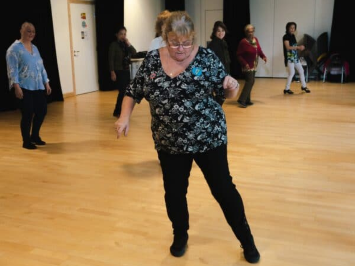 A line dancing instructor teaching her class some new moves