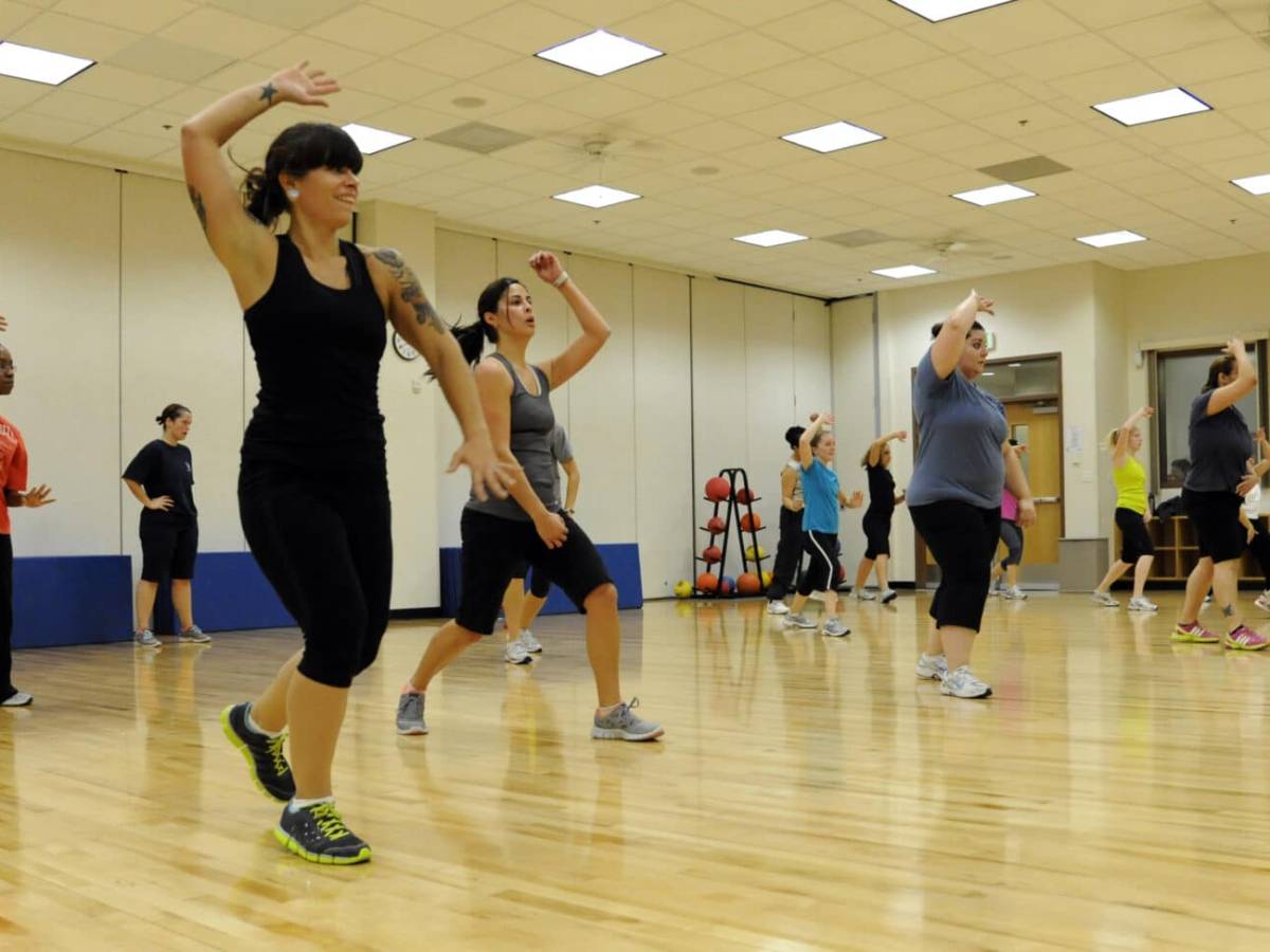 A group of women exercises in a community hall