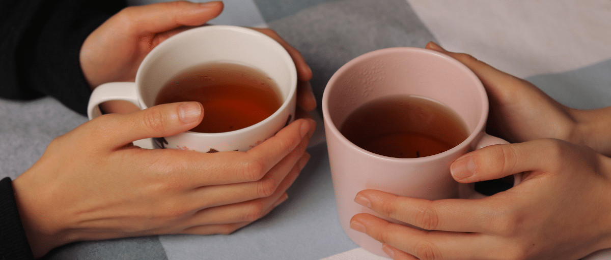 Hands cupping warm drinks