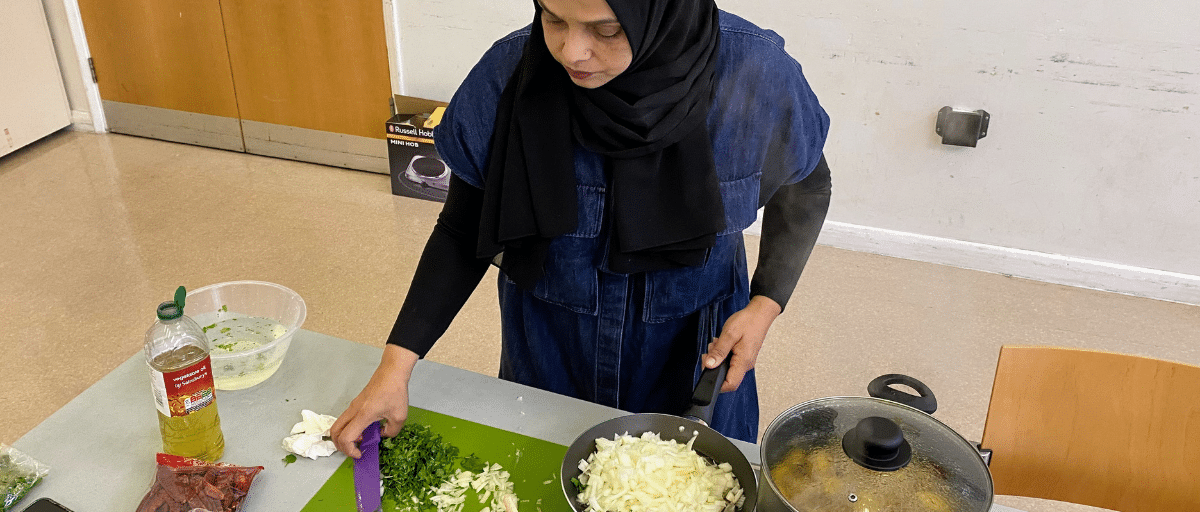 Session leader, Moni, is preparing ingredients to cook