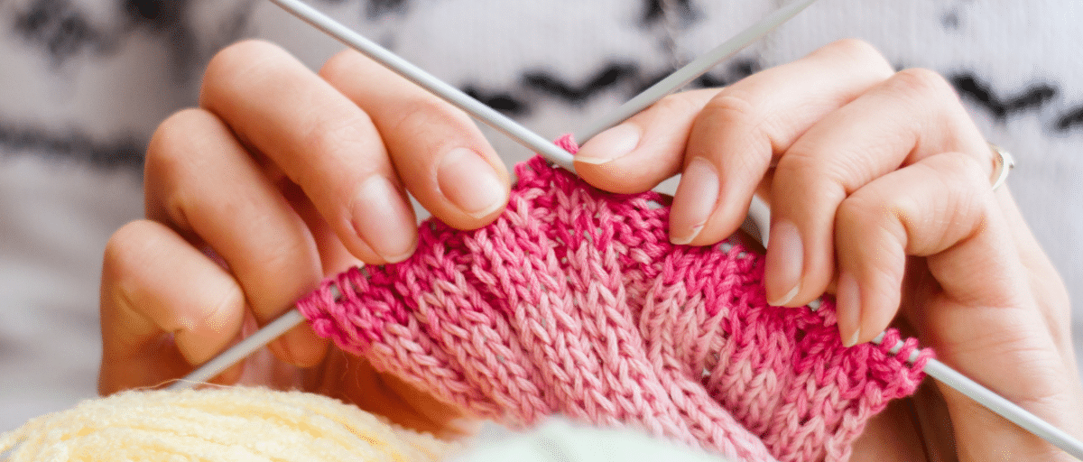 Close up photo of hands knitting at Southern Grove Knitting Club