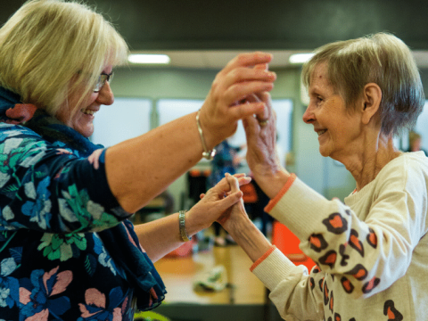 Two senior aged women dancing together at the Linc Community Centre