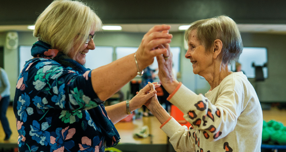 Two senior aged women dancing together at the Linc Community Centre