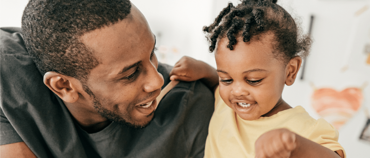 A dad and his young daughter play together