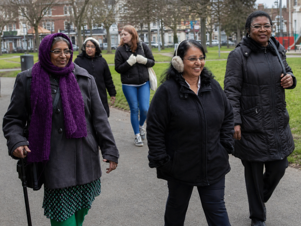 Women walking together in the park and chatting.