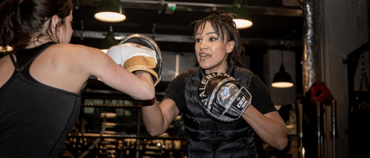 Boxing coach, Valerian Spencer, sparring with another woman