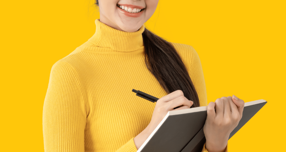 A woman writing in a notebook