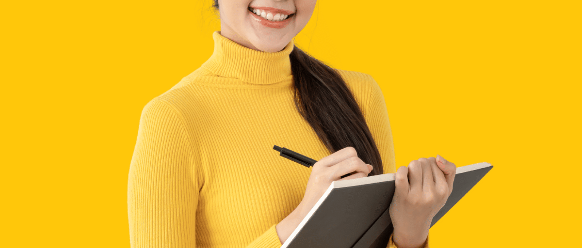 A woman writing in a notebook