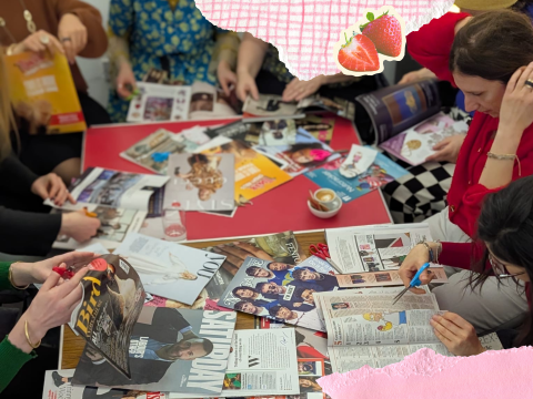 A group sit around a table cutting images from magazines to create a collage.