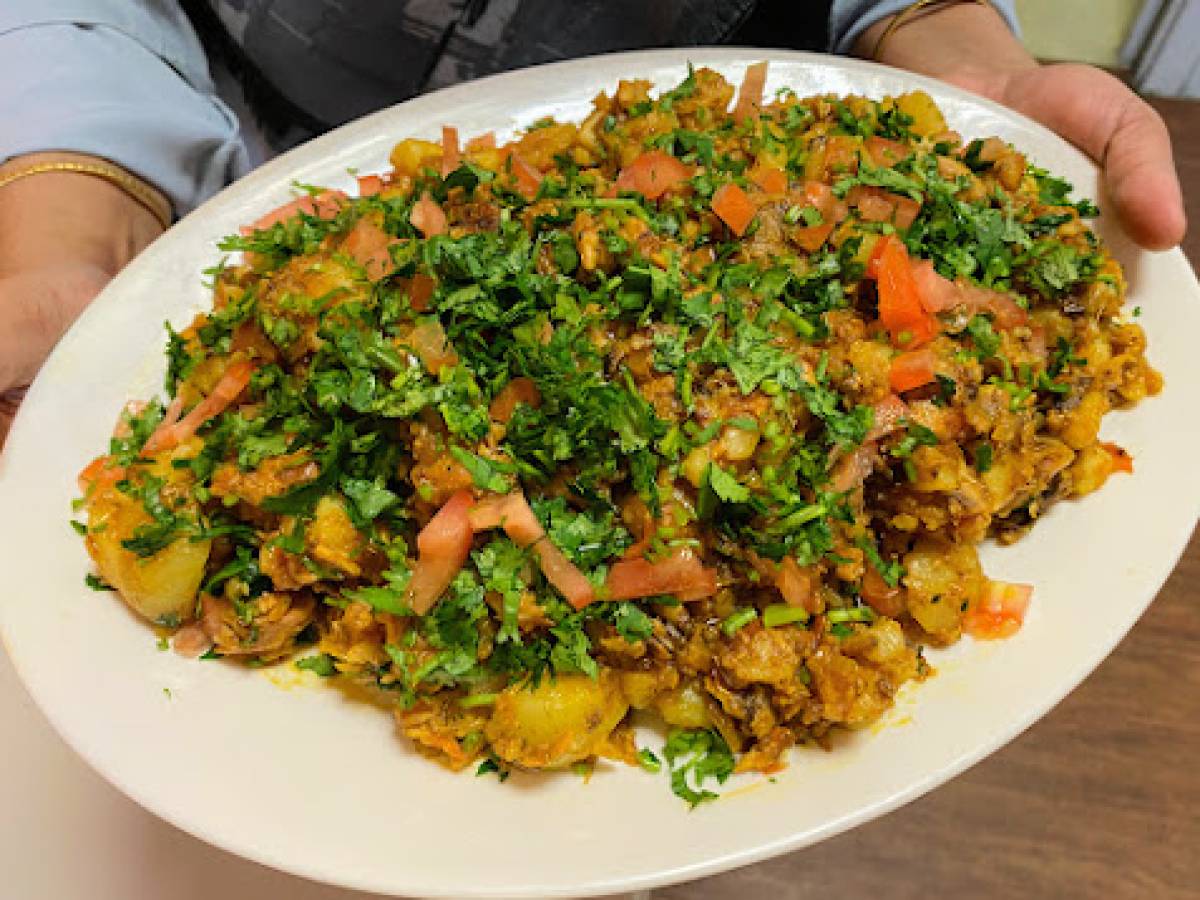 A colourful plate of bengali food cooked in a healthier way, with lots of herbs and vegetables