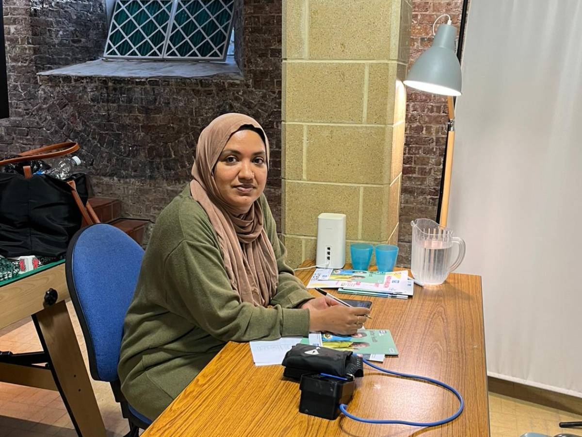 A public health practitioner is ready to carry out vital heart health checks in a community space