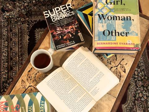 A coffee table scattered with books