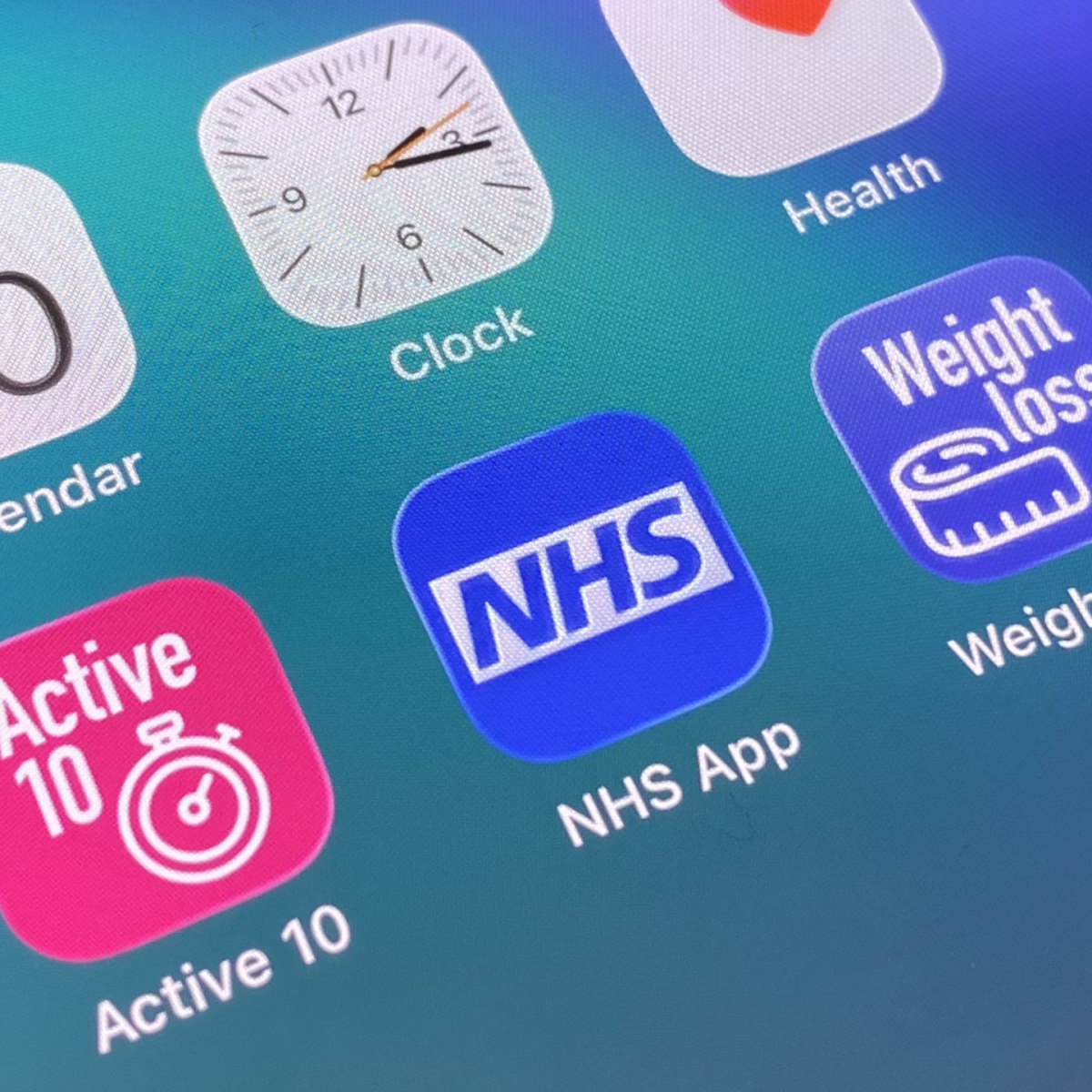 Close up of a phone showing various health apps